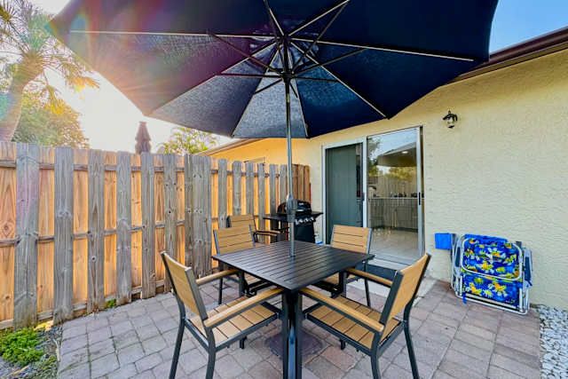 Patio dining set and grill by the sliding doors at 17318 Fort Myers Beach