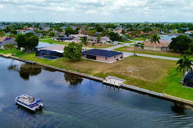 Aerial view of the canal-front home and private dock at 1818 SE 6th Ave, Cape Coral