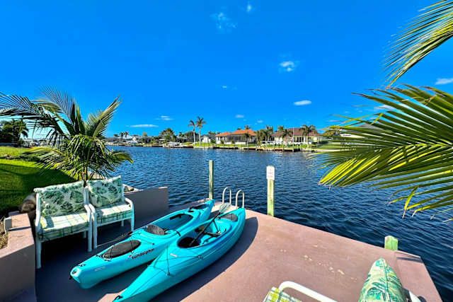 Two kayaks on the private dock beside the Gulf-access canal at 2549 SW 38th St, Cape Coral