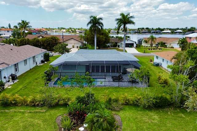 Aerial view of the screened pool and lawn at 510 SW 51st Ter, Cape Coral